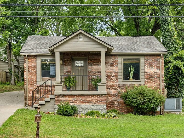 Brick home exterior with repainted trim and porch